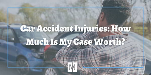 Man looking at car accident holding his neck in pain