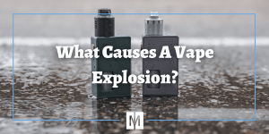 Two vapes sitting on ground next to puddle